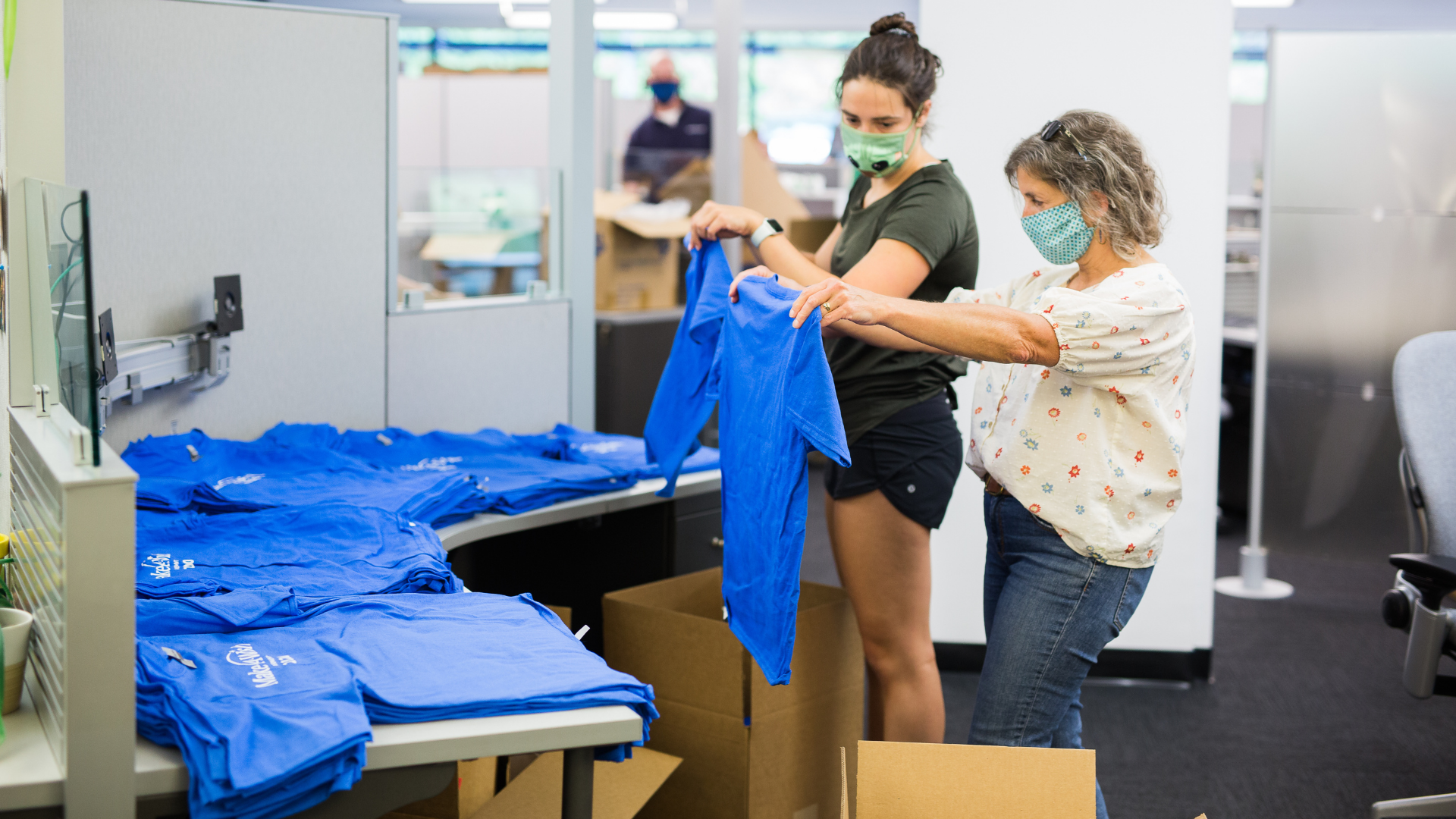 Photo of Instrumart employees preparing gift boxes for Make-A-Wish.